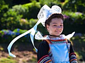 France,Finistere,parade of the 2015 Gorse Flower Festival in Pont Aven,child in Pont Aven headdress and costume