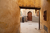 Morocco,Two men outside entrance to Sidi Tijani Mosque,Fez