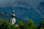 Germany,Stormy clouds behind Ruhpolding church,Bavaria