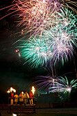 UK,England,People dressed as clergy on stand with fireworks behind them at Newick bonfire night,East Sussex