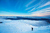 UK,Scotland,Man descending slopes of Beinn Respiol on Ardnamurchan peninsula,Highlands