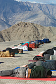 Yoga 'salutation to the sun' performed in front of the Shanti (Peace) Stupa overlooking Leh. Ladakh,Province of Jammu and Kashmir,India