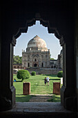 Tourists walking from the Bara Gumbad to the Sheesh Gumbad,Lodi Gardens,Delhi. Lodi Gardens is a beautiful park in Delhi,popular with Indian couples and families. It covers 90 acres and includes various tombs of the Lodi dynasty,which ruled over nor