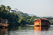 India,Cargo Barge On The Mandovi River With Chapel Of St Catherine In Background,Old Goa