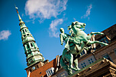 Denmark,Bishop Absalon equestrian statue in Hojbro Plads and views of Nikolaj on the background,Copenhagen