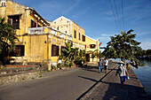 People Walking Along Waterfront Of Historic Town Of Hoi An,Vietnam