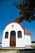 Greece,Halkidiki,Whitewashed Greek Orthodox church overlooking Mediterranean sea,Nea Roda