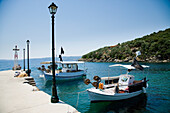 Greece,Halkidiki,Traditional wooden fishing boats moored in small harbour,Pirgadikia