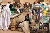 Niger,Tuareg Men Shopping For Garments At Housa Trader's Stall. Agadez's Livestock Market,Agadez