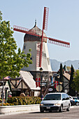 Car Passing Windmill,California,Usa