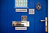 Close Up Of Blue Door With Signs