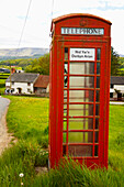 Telefonzelle mit einem Schild, auf dem steht, dass Münzen auf Walisisch nicht angenommen werden, Brecon Beacons, Wales