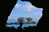 Man silhouetted against La Portada rock arch on the coast of Chile,La Portada,Antofagasta,Chile