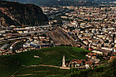 Bird's eye-view of a vineyard,church and the city of Bolzano,Italy,Balzano,Italy