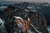 Sunlight kisses a snow-dusted peak in the Dolomite Mountains,Ortisei,Italy
