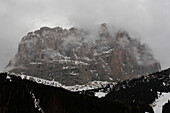 Snow clouds cover Sassolungo Langrofel,the famous Dolomite mountain in Italy,Val Gardena,Italy