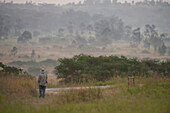 Man stands alone admiring the scenery in Queen Elizabeth National Park in Uganda,Africa,Uganda