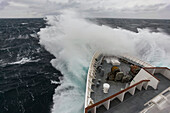 Waves crash against a cruise ship maneuvering through the Drake Passage,Antarctica