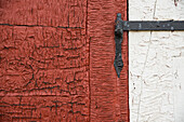 Old wrought iron hinge on a weathered door and frame,Sisimiut,Greenland