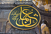 Close-up of one of the eight Arabic Calligraphic Roundels,signs in the interior of the Hagia Sophia Grand Mosque,360 AD,and is a UNESCO World Heritage Site,Istanbul,Turkey