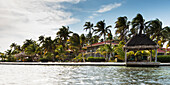 Resort-Unterkünfte und Palmen in der Karibik, Belize