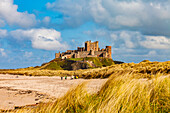 Menschen an einem Strand in der Nähe von Lindisfarne Castle, Holy Island, Northumberland, England