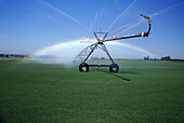 Rainbow shining through the mist from the spray of irrigation equipment on farmland in the Willamette Valley,Oregon,USA