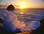 Waves breaking and splashing along the shore at sunset in Ecola State Park,Cannon Beach,Oregon,United States of America