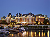 The Fairmont Empress hotel and boats in the Inner Harbour in downtown Victoria at dusk,Victoria,British Columbia,Canada