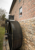 The miller looks on as the wheels turn the water at the Aldie Mill in Loudoun County,Virginia.