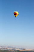 A hot air balloon flies over California,east of Napa Valley.,Winters,California