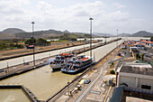 Two passenger vessels are positioned in the Miraflores Locks of the Panama Canal.,Panama