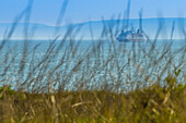 A distant boat off of Jar Island near Vansittart Bay in the Kimberley Region of  Northwest Australia.