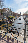 Bicycle parked on canal bridge,Lekkeresluis in Amsterdam,Amsterdam,North Holland,Netherlands