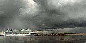 Cruise ship in the harbour of South Shields under a dramatic stormy sky,South Shields,Tyne and Wear,England