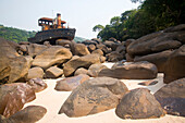 Half of a large cargo vessel sits on a pile of boulders.,Congo River,Democratic Republic of the Congo.