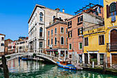 Canal with footbridge and colourful buildings,Venice,Veneto,Italy