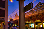 Streets are lit at dusk outside a plush hotel in St. Moritz. Glitzy designer shops attract high-end tourists for a glamorous vacation in the Swiss Alps,St. Moritz,Switzerland