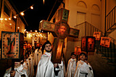 During Holy Week in Mendrisio,Christians dressed in white robes carry canvas lanterns,some over a hundred years old. The crosses are lit by candles and somberly carried through the streets for a passion play processional,Mendrisio,Switzerland