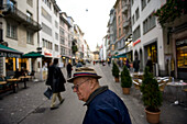 Senior man strolls through a city market in Zurich,Switzerland,Zurich,Switzerland