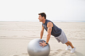 Man Doing Push-Ups at Beach