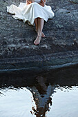 Bride Sitting by edge of Lake,Ontario,Canada