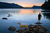 Teenager and Dog looking at Sunset,Fulford Harbour,Salt Spring Island,British Columbia,Canada
