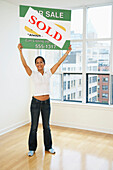 Woman Holding Sold Sign
