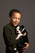 Little Boy Holding Dog