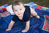 Baby Playing on Blanket Outside