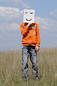 Boy in Field Holding Smiley Face