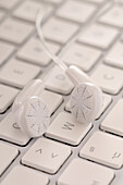 Close-Up of Ear Phones on Keyboard