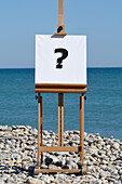Easel with Question Mark on Canvas