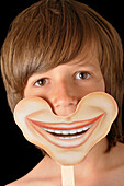 Boy Holding Smiling Mask